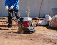 Construction crew using a Tomahawk Power Vibratory Rammer for trench compaction.