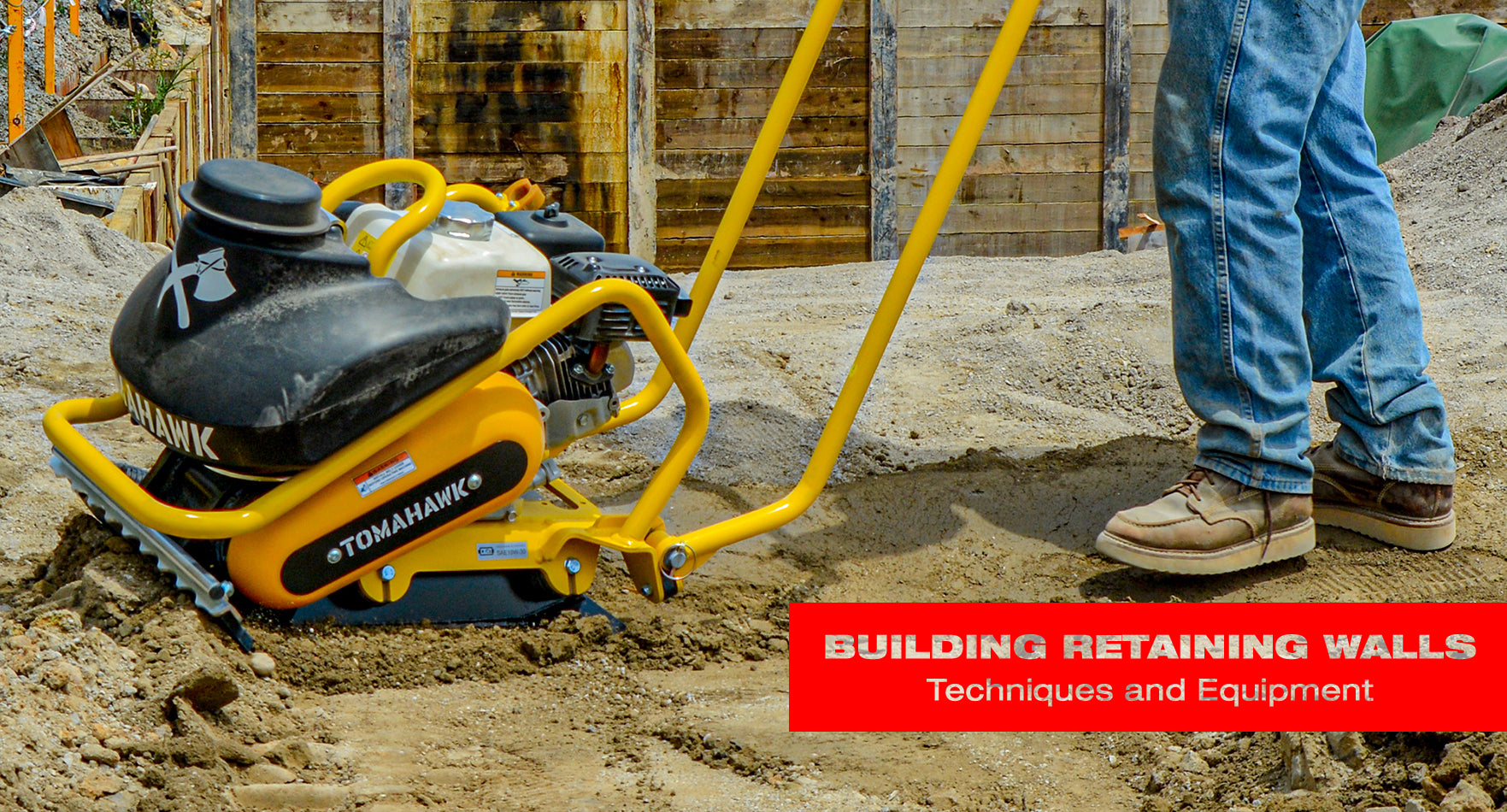 Man using a plate compactor for soil compaction techniques to build retaining walls. 