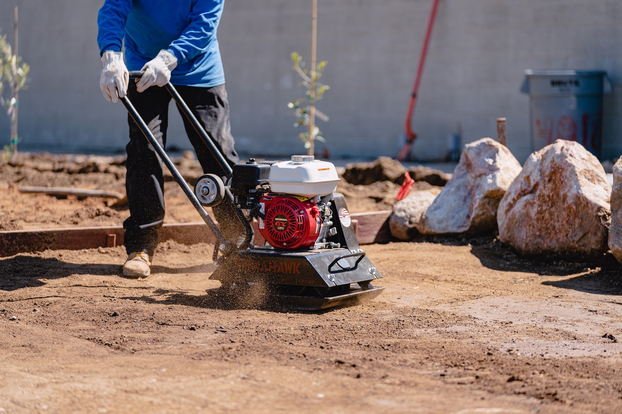 Construction crew using a Tomahawk Power Vibratory Rammer for trench compaction.